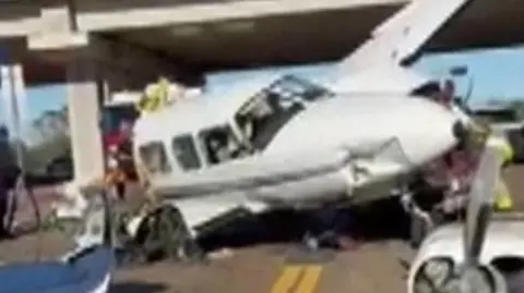 Plane split in two on highway