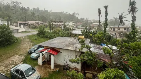 This picture shows a general view of a residential area as rain falls ahead of the arrival of the forecasted Super Typhoon Bavi in Saipan, Northern Mariana Islands, on July 5, 2026.