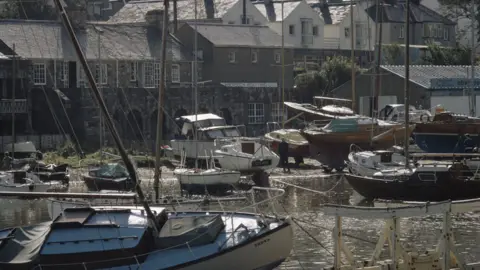 Getty Images Abersoch harbour with boats and houses beyond the quayside