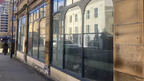 LDRS Exterior view of stone shop front in a city centre 