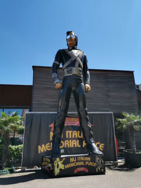 Europark Milano A painted towering Michael Jackson statue standing on a plinth which reads "MJ ITALIAN MEMORIAL PLACE"