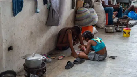 Children gather in a displacement camp at the Lycée Marie Jeanne school in Port-au-Prince, Haiti 