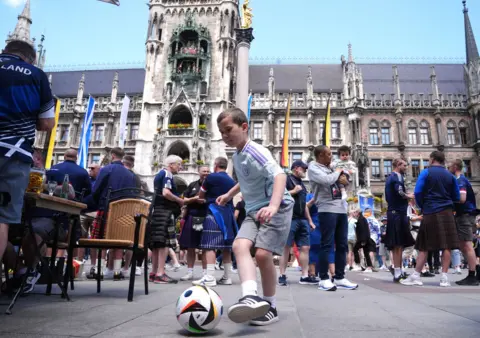 PA Young boy playing with football