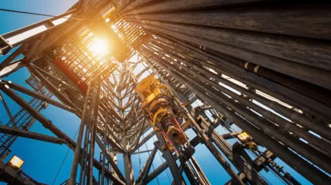 A gas drilling rig seen from the ground