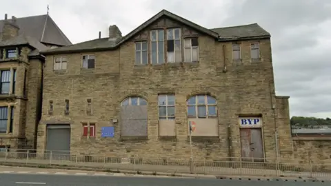 A large stone building in poor repair