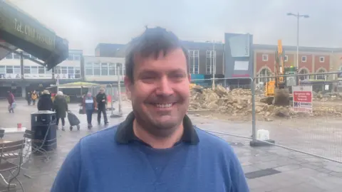 Photograph of Michael Barlow, who runs the Bow Street Cafe on the market square in Ashton-under-Lyne.