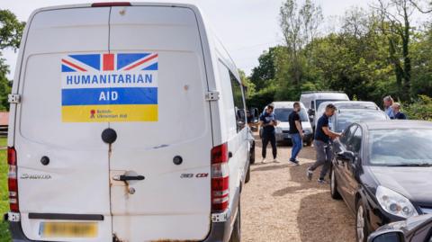 White van with 'humanitarian aid' sign written on it