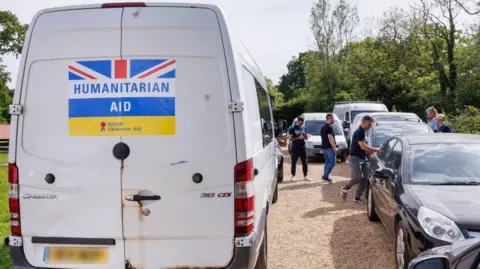 TfL White van with 'humanitarian aid' sign written on it