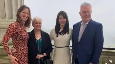 Aisling Courtney who has short ginger hair, Anne Page who has short white hair, Aly Coyle who has long brown hair and Mike Nesbitt ho has short white hair. Pictured together at Stormont. 