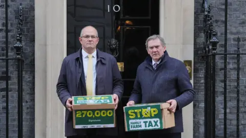 PA National Farmers' Union (NFU) president Tom Bradshaw (left) and NFU Cymru president Aled Jones handing in a petition at 10 Downing Street, central London, over the changes to inheritance tax (IHT) rules in the recent budget which introduce new taxes on farms worth more than £1 million