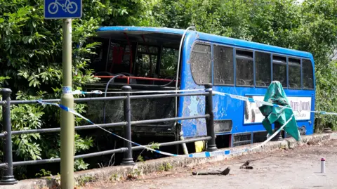 The scene at Bishopstoke Road, Eastleigh, Hampshire, after a Blustar bus carrying pupils from Barton Peveril Sixth Form College came off the road and ended up in a river. The double-decker bus carrying sixth-form college students crashed off the road and ended up in a river, leaving three people being taken to hospital as "high priority" patients with 14 others treated at the scene.