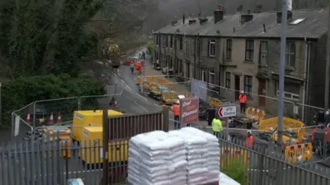 A shot of a busy road near Hebden Bridge with road works 