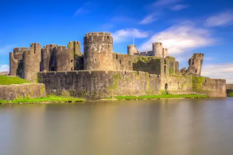 Getty Images Caerphilly Castle, its moat under blue sky