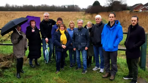 A group of residents at the site on Beverley Road, including councillor Paul Drake-Davis and Tim Mitchell (wearing a blue coat)