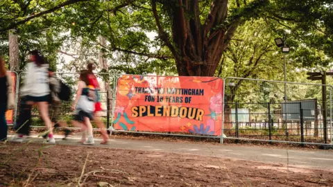 Louisa Mae Photography Crowds arriving walking past a Splendour banner