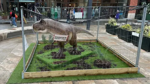 Local Democracy Reporting Service A model T-rex in a cage in Lincoln city centre