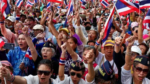 Reuters Anti-government protesters gather at the Victory Monument with Thai flags. The entire image is filled with them.