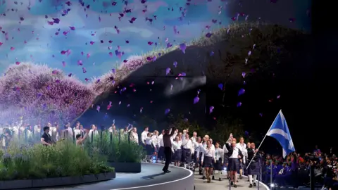 Getty Images Team Scotland pass the garden as they enter the Hydro to the biggest roar of the night