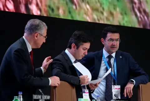 EPA COP29 President Mukhtar Babayev (L) speaks with COP29 Lead Negotiator Yalchin Rafiyev (C) during a plenary session at the United Nations Climate Change Conference COP29 in Baku