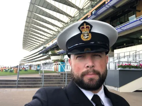 Jon Over A man in Navy Uniform taking a selfie.