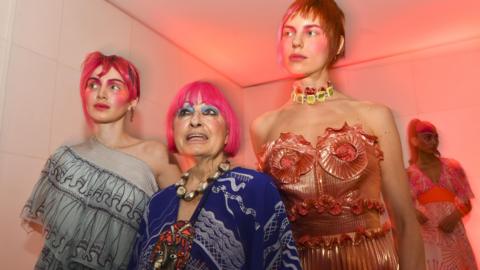 Dame Zandra Rhodes poses for photographs as she showcases her collection at Zandra Rhodes presentation during London Fashion Week September 2018