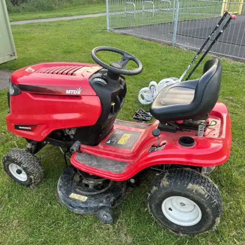 Dean Mitchell A red riding lawnmower with a black seat.