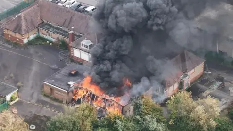 aerial close-up of fire at former school