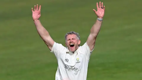 Glamorgan bowler Timm van der Gugten throws his arms up in the air as he appeals for a decision