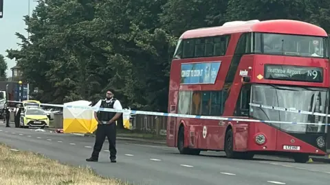 @CotswoldGirls/X An image of a bus and two forensic tents within a police cordon.