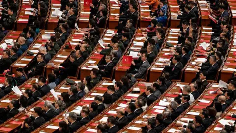 Getty Images Delegates listen to speeches at the closing session of the Chinese People's Political Consultative Conference (CPPCC) at the Great Hall of the People on March 11, 2026 in Beijing, China