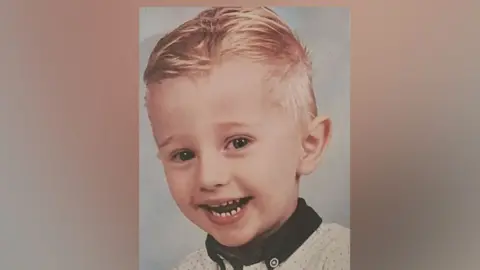 Essex Police/family handout Freddie smiles at the camera as he is professionally photographed. He has blond hair and has a joyful smile at the camera. He is wearing a navy collar shirt.