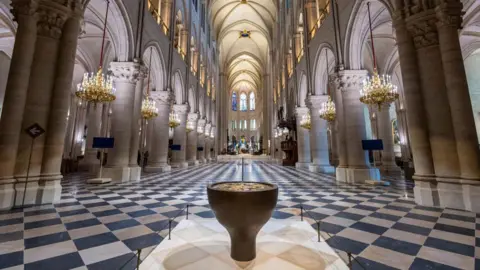 AFP via Getty Images The interior of the church, with vaulted ceilings and diamond-patterned floors.