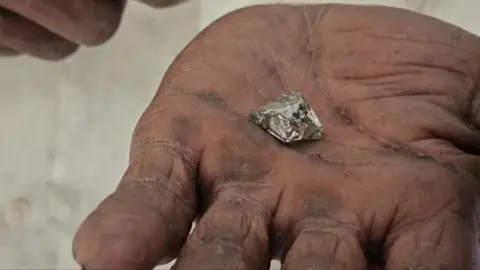 PTI A labourer holds up the diamond 