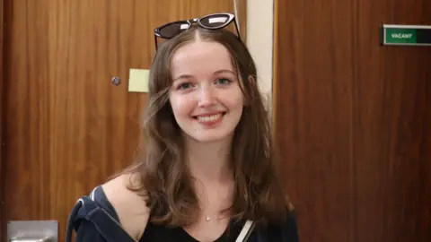 Abi smiles at the camera. 