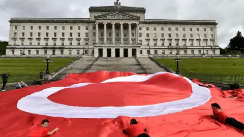 Pacemaker A large red flag with a white circle on it lies at the bottom of the steps at Stormont 