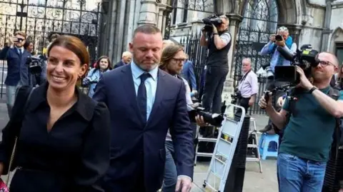 Reuters Coleen Rooney attending the 2022 lawsuit  with her hubby  Wayne

