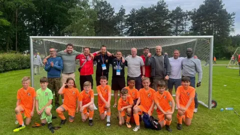 St Johns FC/Neil Frost The St Johns FC under 10s team with their dads