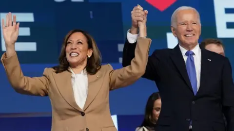 Reuters Joe Biden and Kamala Harris arm-in-arm at the Democratic National Convention