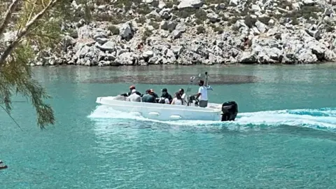 Reuters People ride in a speedboat