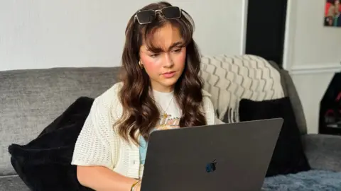 BBC Macy Landon-Jones with her laptop