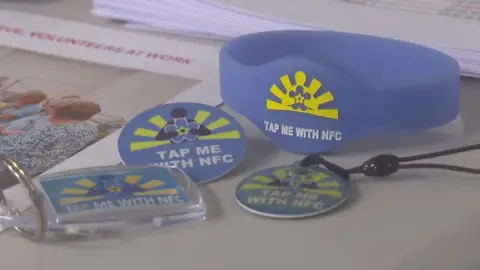 The four types of Guardian Angel devices - a keyring, wristband, badge and bag tag. They are sky blue colour.