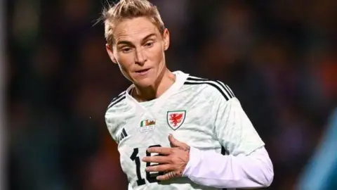 Getty Images A woman with short blonde hair wearing a while sports shirt