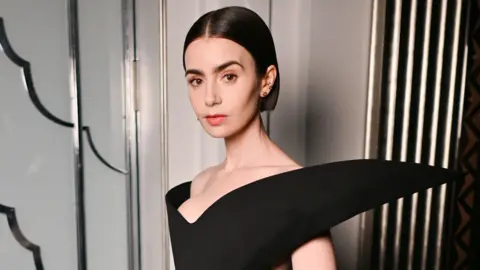 Lily Collins attends the Harris Reed Autumn / Winter 2026 show during London Fashion Week at Claridge's Hotel on February 19, 2026 in London, Englan