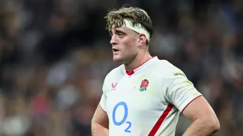 Alex Coles standing with his hands on his hips during England's match against France in the Six Nations