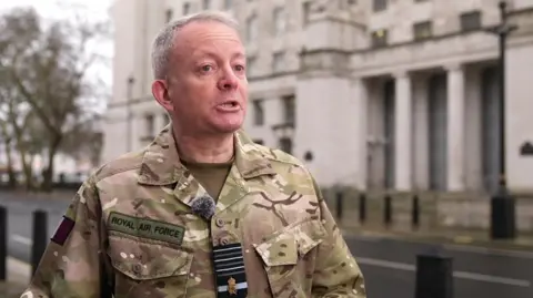 BBC Richard Knighton in a military camouflage jacket that says Royal Air Force.