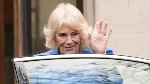 PA Media Queen Camilla waves to public as she enters a car