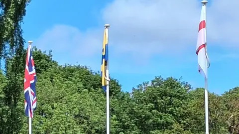 Mel Metcalf A union jack, flag of County Durham and a St George's flag all flying.