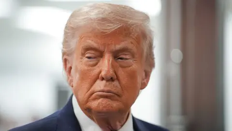 A close-up picture of US President Donald Trump's face.