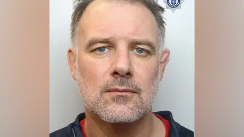 A police mugshot of Paul Whitehurst, looking at the camera