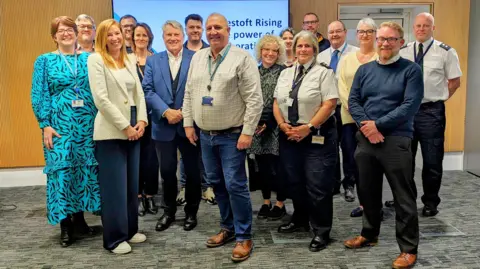 EAST SUFFOLK COUNCIL A group of 16 people standing together all of whom were associated with Lowestoft Rising 